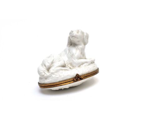 A mid 18th century French soft paste Blanc de Chine bonbonniere, probably Mennecy, in the form of a recumbent spaniel, oval f