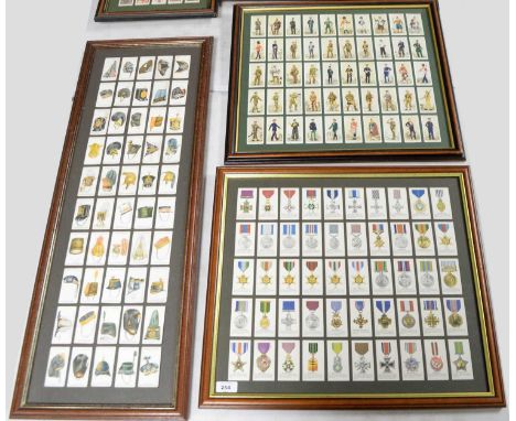 Framed military interest cigarette cards, including: a set of Player’s Cigarettes ‘Military Head-Dress’ cigarette cards, in f