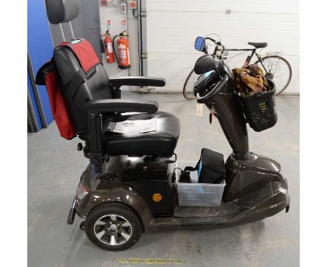 A Mango E-Mobility Leopard mobility scooter, in brown, with manual.