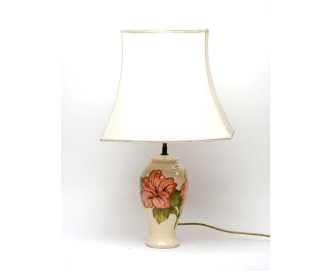 A Moorcroft ‘Hibiscus’ pattern table lamp, tubeline decorated with flowers and leaves on a cream ground, painted and impresse