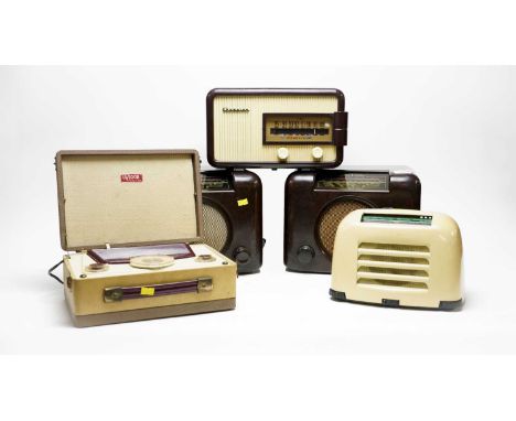 Two Bush vintage radios, type DAC 90A, each in brown Bakelite case, 30cms wide; together with a Champion Megacycle radio; a M