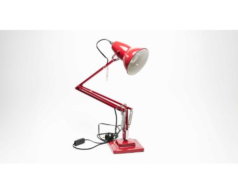An Anglepoise desk lamp, in red. 
