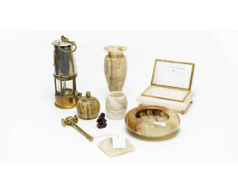 A selection of vintage stone desk accessories, including: a gilt detailed sarcophagus trinket box; a table lighter; an ashtra