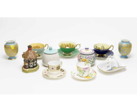 An Aynsley cobalt blue and gilt tea cup and saucer, with rose decoration to bowl interior, signed J.A. Bailey; together with 