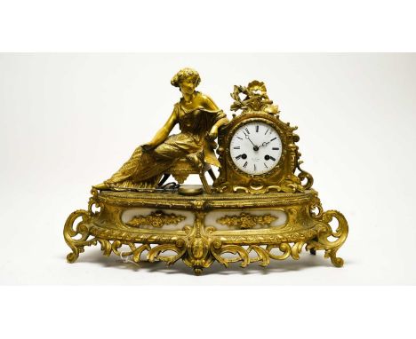 A late 19th Century French figural mantel clock, by Henry Marc, the white enamel Roman dial signed, within a gilt metal case 