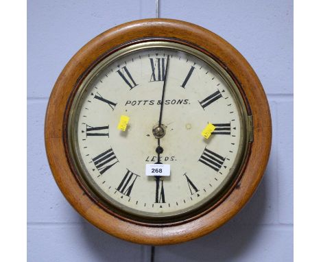 A 19th Century oak cased railway wall clock, the cream enamel Roman dial inscribed ‘Potts &amp; Sons, Leeds’, 34cms diameter.