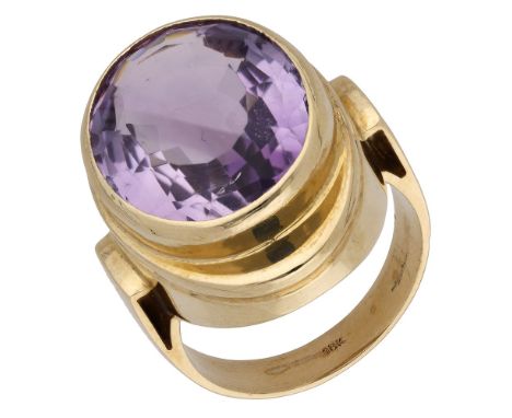 An amethyst dress ring, the oval mixed-cut amethyst collet-set to an oval mount, stamped ‘18k’, ring size O.  £150-£200