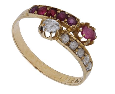 A ruby and diamond crossover ring, 1911,  the terminals set with a cushion-shaped ruby and old brilliant-cut diamond, between