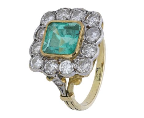 An emerald and diamond cluster ring, the octagonal mixed-cut emerald centred within a brilliant-cut diamond cluster, the diam