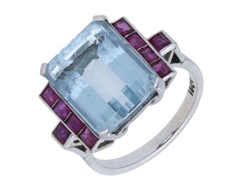 An aquamarine and ruby ring, the step-cut aquamarine claw-set between two channels of rectangular-cut rubies, the shoulders s