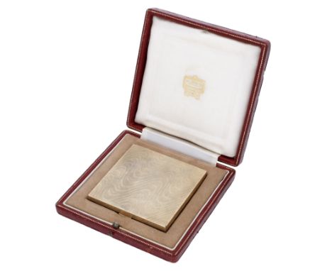A 9ct gold square compact by Kurt Weiss, 1955, retailed by Cartier,  decorated throughout with undulating waves, and opening 
