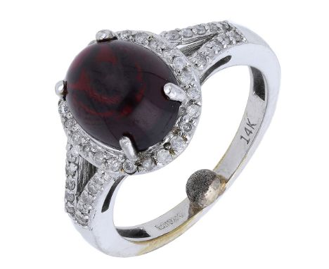 A 14ct white gold garnet and diamond cluster ring, the garnet cabochon within a brilliant-cut diamond cluster, to similarly-s