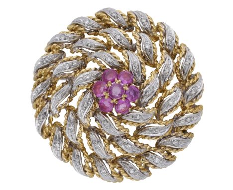 A ruby and diamond cluster brooch, circa 1960, set with a flowerhead of circular-cut rubies, within a bombé bicoloured surrou