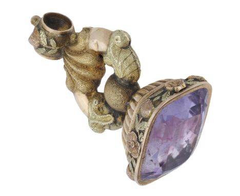 An amethyst fob seal, circa 1830, inset with a rectangular mixed-cut amethyst, the mount with reeded, scroll, and foliate dec