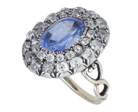 An early 19th century sapphire and diamond cluster ring, the oval-cut  sapphire within a two-row surround of cushion-shaped d