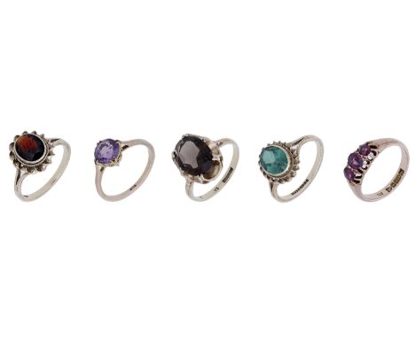 A collection of gem-set rings, to include four single stone rings set with garnet, amethyst, smoky quartz and green paste res