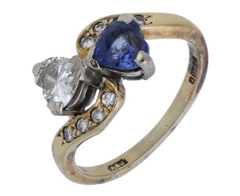 An 18ct gold sapphire and diamond crossover ring, the heart-shaped sapphire and diamond claw-set between diamond set crossove