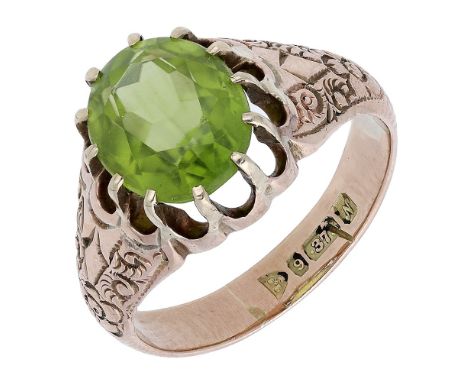 A peridot ring, 1913, the oval-cut peridot within a gold tapering mount engraved with foliate decoration, Chester hallmark, r