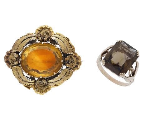 A mid 19th century citrine brooch and a smoky quartz ring, the brooch set with an oval mixed-cut citrine within a filigrée su