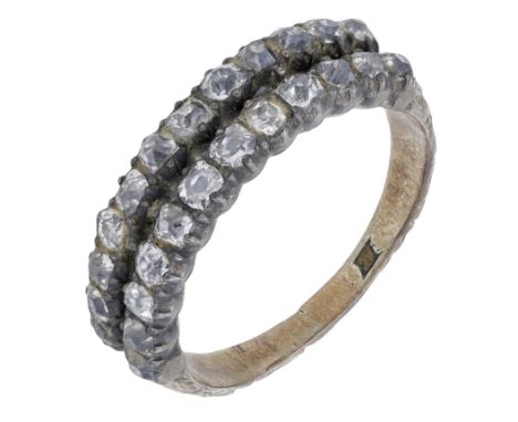 An early 19th century diamond ring, the two rows of old-cut diamonds within closed back settings, between foliate decorated s