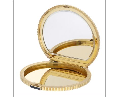 An 18ct gold circular compact, by Kurt Weiss, 1967, retailed by Garrard, decorated with textured whorl design to the top and 