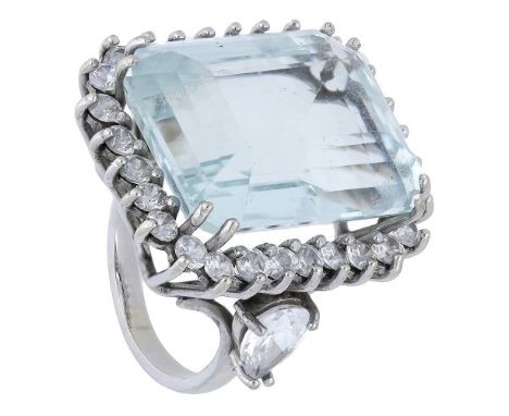 An aquamarine and diamond cluster ring, the step-cut aquamarine claw-set within a surround of brilliant-cut diamonds, to pear