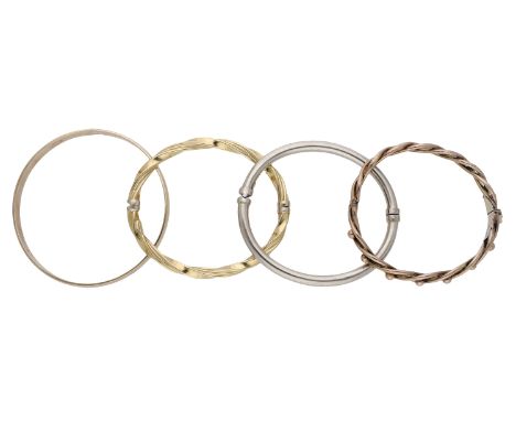 Four bangles, comprising a plain polished 9ct gold bangle, a hollow bangle, stamped ‘14K’, an openwork bangle with bead detai