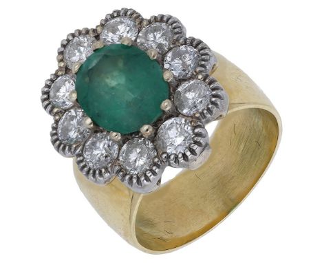 An 18ct gold emerald and diamond cluster ring, the oval mixed-cut emerald claw-set within a grained surround of brilliant-cut