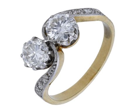 A diamond two stone ring, of crossover design, the two brilliant-cut diamonds claw-set between millegrain single-cut diamond 