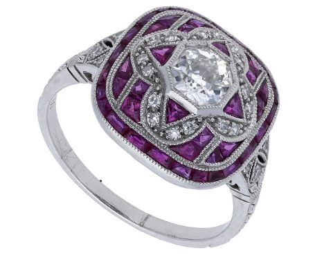 A ruby and diamond panel ring, the domed panel centred with an octagonal old-cut diamond and millegrain set throughout with v