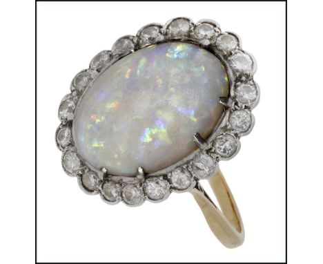 An early 20th century opal and diamond ring, the oval opal cabochon within a surround of brilliant-cut diamonds, mounted in p