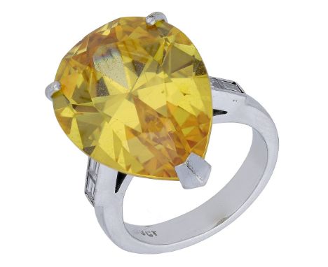 A yellow cubic zirconia dress ring, claw-set to baguette cut-diamond shoulders, stamped ‘9CT’, total diamond weight approxima