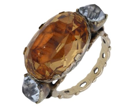 A Georgian topaz set ring, the central oval topaz within gold closed back foiled setting engraved with stylised foliate detai