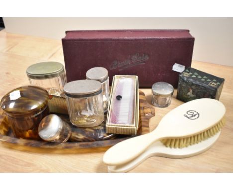 A selection of vintage dressing table items, including tortoiseshell effect mirror, tray and trinket box and bone handled bru