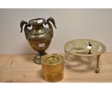 An Indian brass embossed vase, measuring 23cm tall, an Edwardian brass trivet, and a cylindrical tea caddy