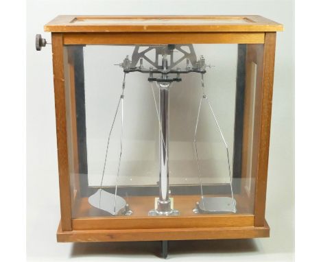 A set of cased weighting scales, British made, mahogany case, glazed on all sides, with sliding front panel and adjustable fe