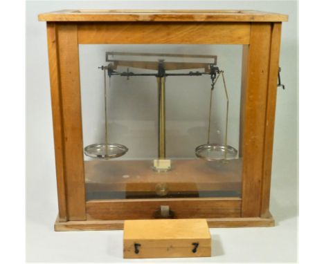 A brass set of cased weighting scales, stamped 250g, pine case glazed on all sides, sliding front panel, also including a set