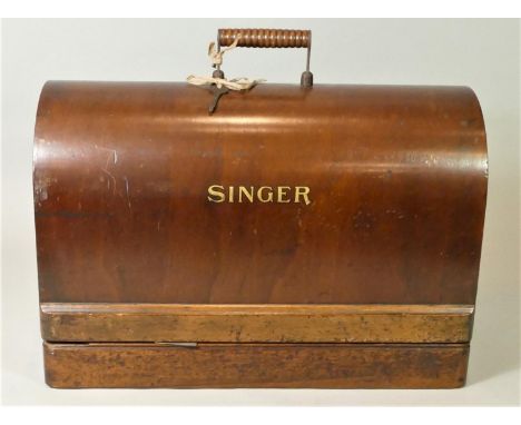 A vintage brass and ebonised handled poultry feather burner, a copper bed warmer and a cased manual singer sewing machine.