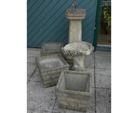 An composite sundial, on a tapered base, height 83cm, width 36cm, together with a bird bath, made of composite and decorated 