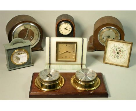 A collection of clocks and wall barometers to include manual wind and quartz examples. (2) 