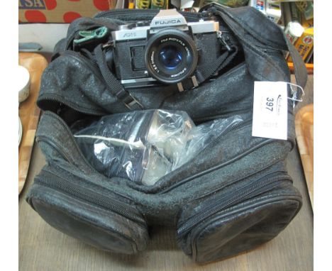 Camera bag containing assorted cameras and accessories, including: Fujica AX-1; teleconverter; flash lights; lenses etc.(B.P.