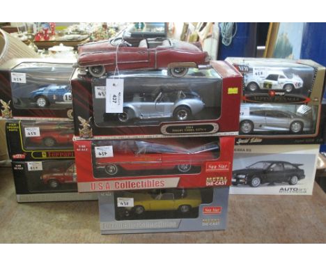 Group of boxed 1:18 and 1:24 scale diecast metal sports cars to include: Cobra Daytona Coupe; Ferrari 328GTS; Ford Escort MK 