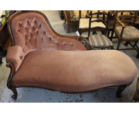 Victorian walnut showframe chaise lounge, having foliate moulded and scrolled pierced decoration, deep buttoned back, serpent