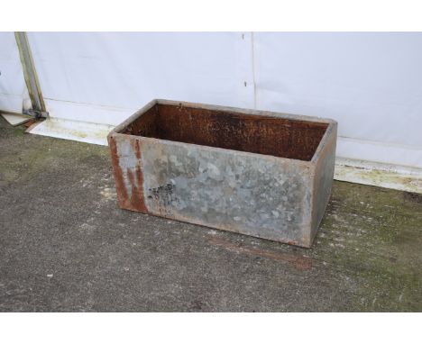 A galvanised metal drinking trough/planter. Of rectangular form with lipped top, npot watertight, H40cm x W90cm x D42cm.