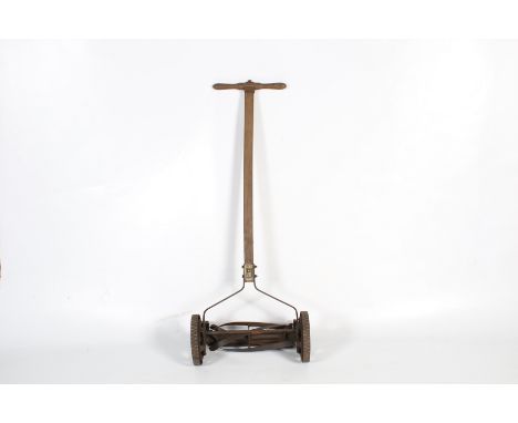 A vintage Flexa pedestrian lawn mower. Serial number W14126, a wooden handle and shaft with metal blades, wheels and wooden r
