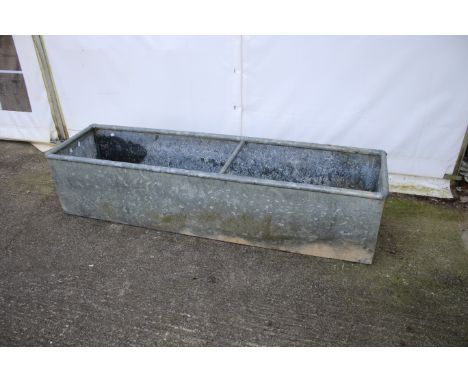A rectangular galvanised metal trough/planter. With wall mounting loops and central bracing bar, H42cm x W183cm x D47cm.