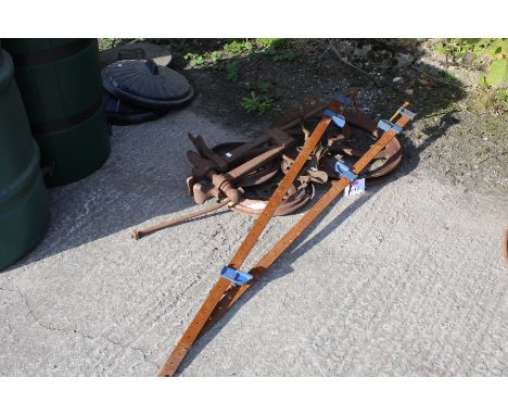 A collection of innteresting sundries. To include two sash clamps, a pulley wheel, manhole and cover, large vice and hand cra