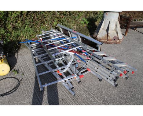 An aluminium scaffolding tower and two ladders. The tower complete with platform and struts, one step ladder and one three st
