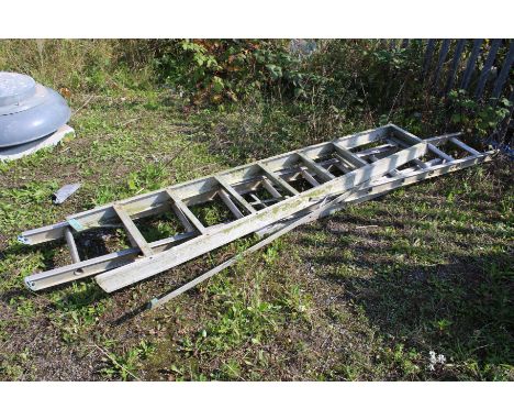 A collection of aluminium ladders. Comprising two step ladders, one requires attention.