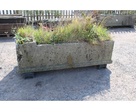 A large concrete livestock drinking trough/planter. Rectangular form raised on a base, chip to both left hand corners, base a